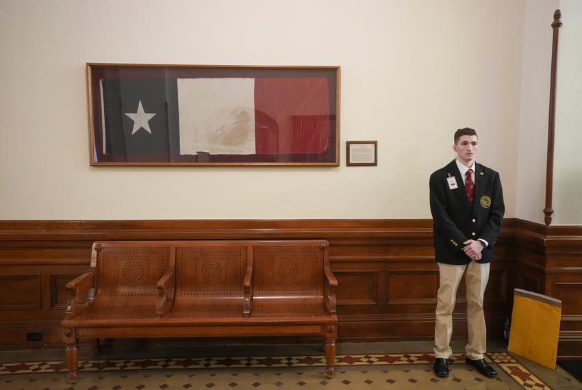House Sergeant Robbie Breslin standing guard in the back hallway of the House chamber of the Texas Capitol on opening day of the 2023 Texas legislative session.