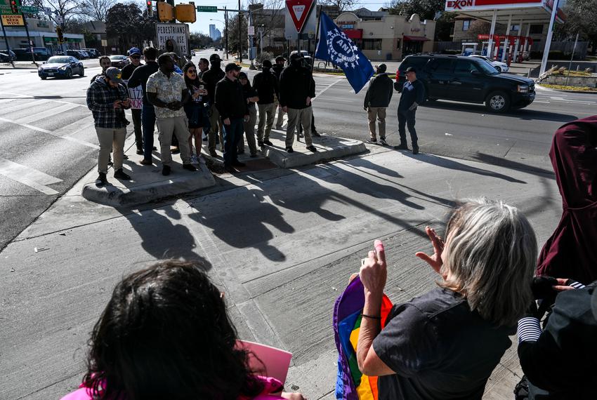 Drag show supporters stand opposite the street corner of anti-drag protesters in Dallas on Jan. 14, 2023.