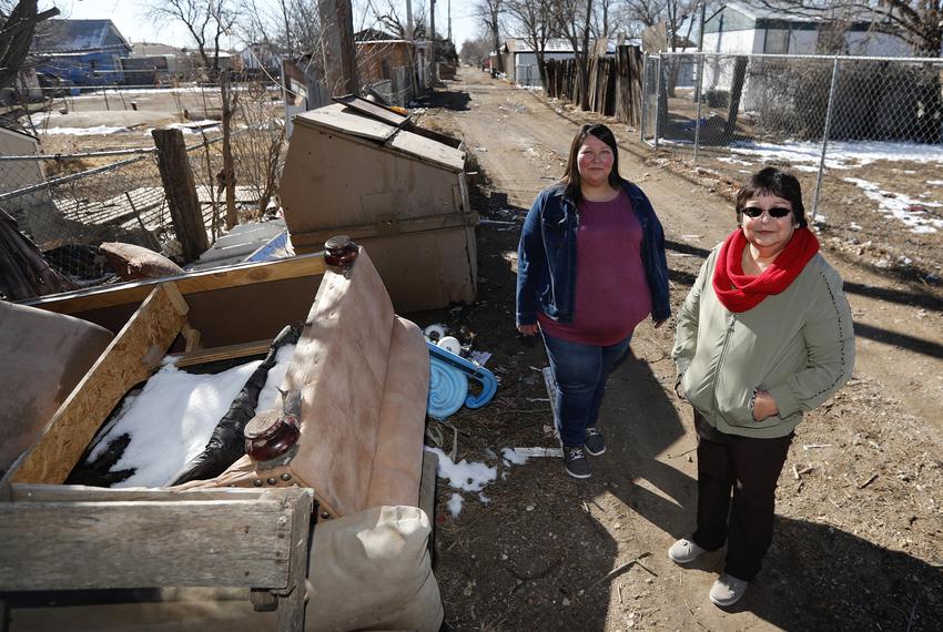Teresa Kenedy, president of the Barrio Neighborhood Planning Committee, right, and Angela Garcia, treasurer of BMPC, stand in an unpaved alley in El Barrio, an Amarillo neighborhood, on Jan. 27, 2023. The pair hope to improve the condition of El Barrio.