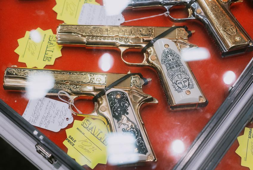 Gold-plated hand guns for sale at a gun show in San Marcos, TX, on Sunday, Jan 29, 2023.
