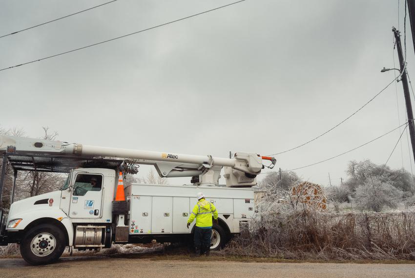Crews from Pedernales Electric Company work to repair downed power lines in Buda on Feb. 1, 2023.