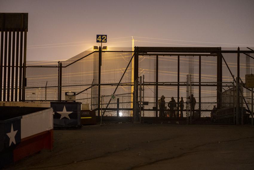 Seen is the Texas National Guard and Texas DPS at the entrance to where hundreds of migrants wait to be processed by U.S. CBP inside a makeshift migrant camp about three hours after Title-42 ended at 9:59 p.m. local time, Friday, May 12, 2023, in El Paso, Texas. Photo by Ivan Pierre Aguirre for The Texas Tribune 

 