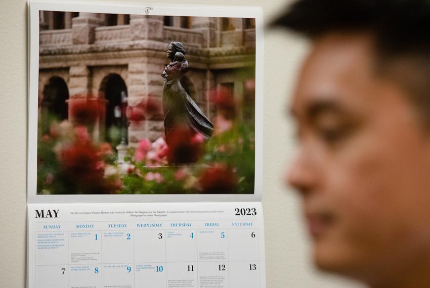 A calendar with the month of May, the last of the session, hangs open behind Steven Wu of Woori Juntos as he speaks with an aide of Rep. Penny Morales Shaw, D-Houston, who sponsored their bill earlier in the session, at her office in the state Capitol in Austin, on May 22, 2023. The Woori Juntos group asked whether Shaw had considered sponsoring their bill for the next session, and if that wasn't the case, whether it would be alright to begin looking for another sponsor.