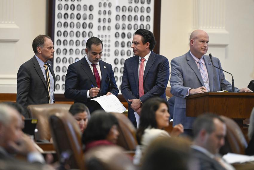 From left: State Reps. Steve Toth, R-The Woodlands, Eddie Morales, Jr., D-Eagle Pass, and Terry Canales, D-Edinburg, wait as Tony Tinderholt, R-Arlington, speaks at the back mike as the impeachment proceedings against Ken Paxton are debated on May 27, 2023.