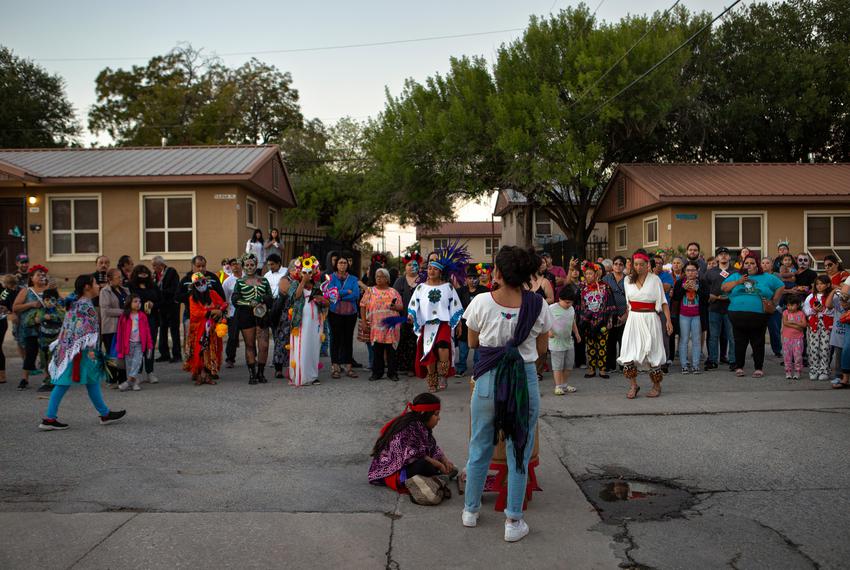 Attendees watch as the Dia De Los Muertos procession continues down the Alazan-Apache neighborhood  in San Antonio, TX on Nov. 1.