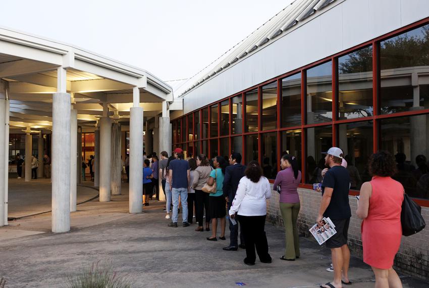 Evening voters cue up in a long line before polls close at the Metropolitan Multi-Service Center in Houston on Tuesday Nov. 8, 2022.