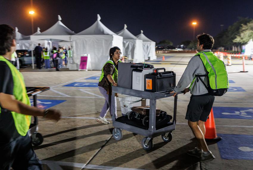 Ballots and scanning machines arrive at central counting after polls close in Houston, Tuesday Nov 8, 2022.