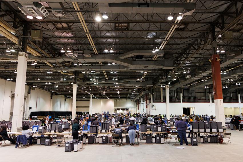 Election workers process ballot machines at the central counting center at NRG Park in Houston on Tuesday, Nov. 8, 2022.