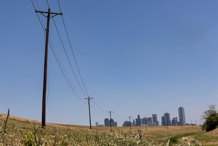 Utility poles lead to downtown Dallas during a heat advisory in Dallas on July 12, 2022.