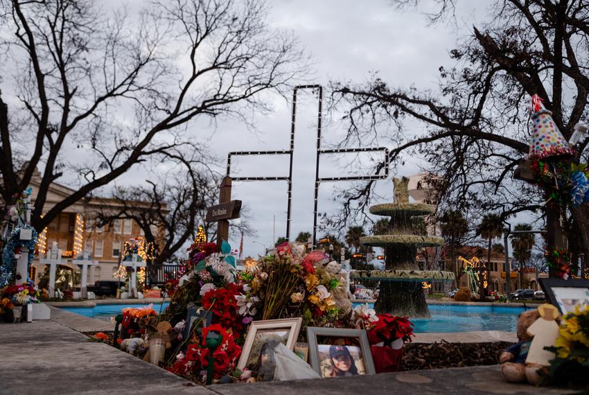 A cross in memory of Eva Mireles is decorated for the holiday season, at the Memorial Plaza in Uvalde on Dec. 21, 2022.