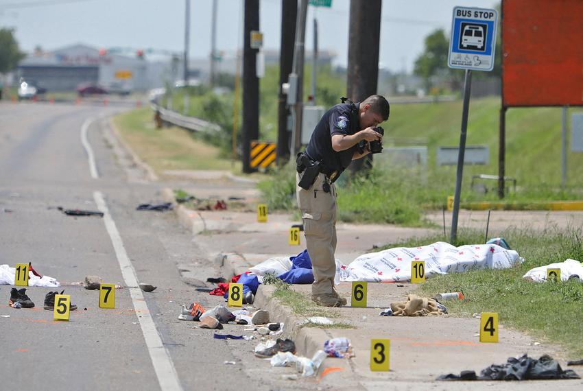 A law enforcement officer photographs the scene after a deadly incident where a car ran into pedestrians near Ozanam Center, a shelter for migrants and homeless, in Brownsville on May 7, 2023.