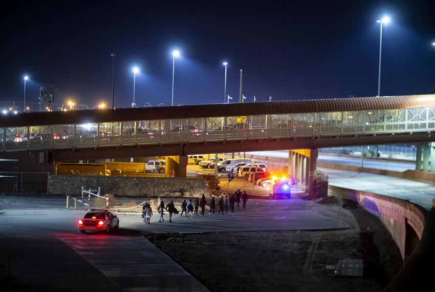 A group of migrants are escorted by U.S. Customs and Border Protection agents near the Paso del Norte International Bridge in El Paso on June 15, 2019.
