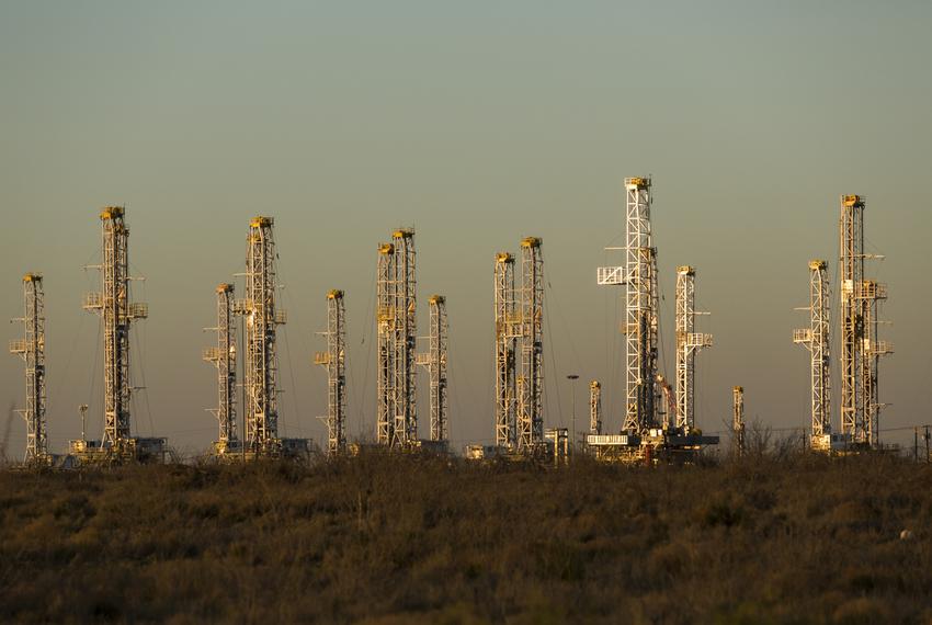 Dozens of stacked oil drilling rigs sit in a yard just north of Interstate 20 between Midland and Odessa.
