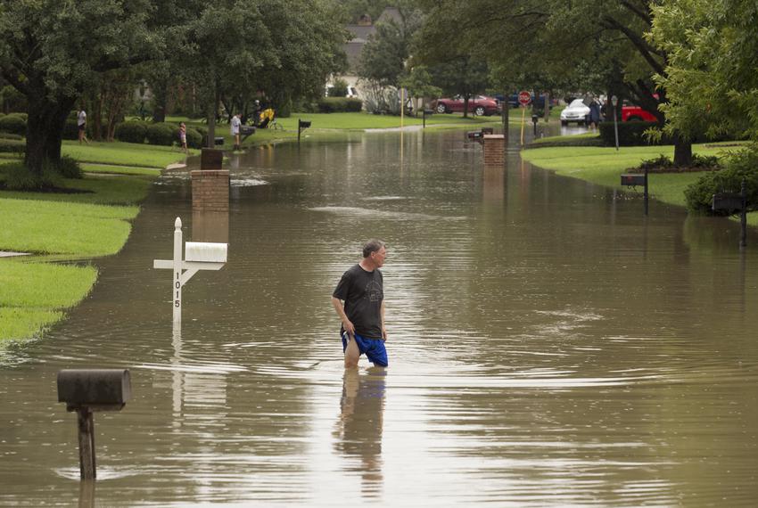 Residents survey their flooded neighborhood near Buffalo Bayou and the Barker Reservoir dam Tuesday Aug, 29, 2017 in Houston,  after Hurricane Harvey.