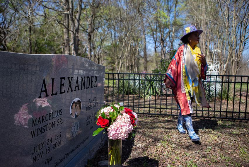 Bringing flowers to her family cemetery,  Rosalind Alexander-Kasparik visits her parents, Marcellus Winston and Juanita Smith, in a shared grave.