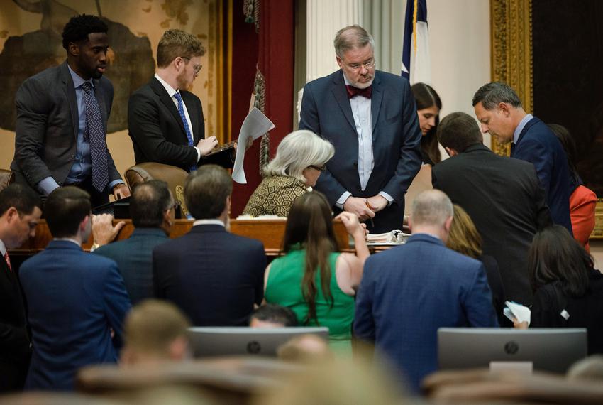 House members converge to discuss a point of order during a late-night session at the Capitol on Oct. 18, 2021.