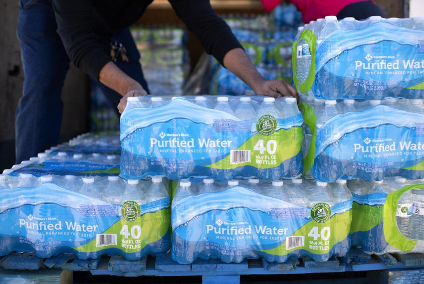 Volunteers unload water during a water distribution and free flu vaccination event at the Holman Street Baptist Church in Houston on Nov. 28, 2022.