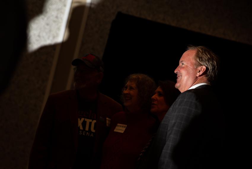 Ken Paxton poses for a photo with guests at his primary election results watch party in McKinney, TX on March 1, 2022.