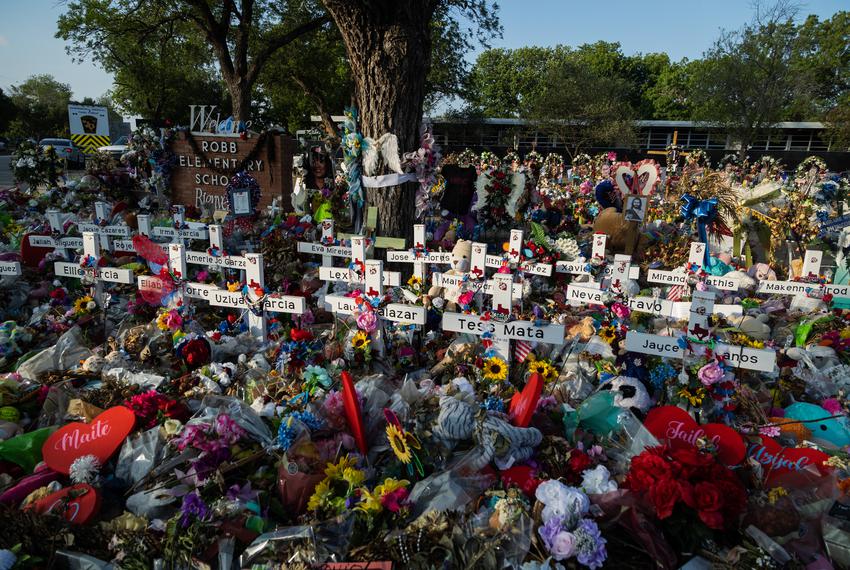 Hundreds of flowers, toys, and candles surround the crosses in memorial of the 21 victims of the school shooting at Robb Elementary in Uvalde, on June 9, 2022.
