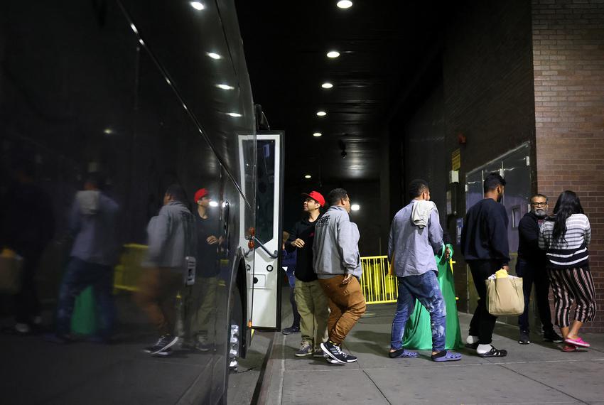 Migrants arriving from Texas by bus disembark at the Port Authority bus terminal in New York City, on May 10, 2023.